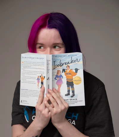 Shelby, peeking over the top of a paperback